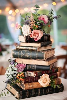 a stack of books with flowers on top