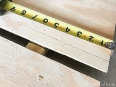 a measuring tape sitting on top of a piece of wood