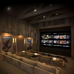 an empty movie theater with couches and movies on the walls