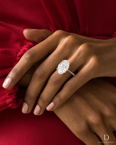 a woman's hand with a diamond ring on her finger