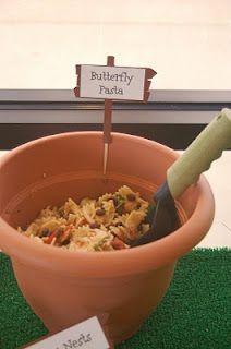 there is a potted plant with food in it and two signs that say butterfly pasta