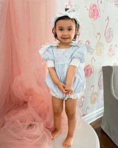 Petite Maison Kids. Made in Turkey. Baby blue linen romper with beading on bodice and adorable shoulder bows. Large tie bow in the back. Faux pearl buttons closure. Soft cotton lining. Composition: 70% Cotton, 30% Linen.