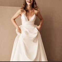 a woman in a white dress is laughing