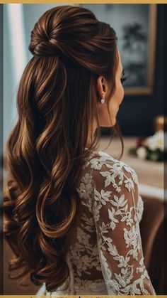 a woman with long brown hair wearing a wedding dress and braided in half updo