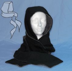 a white mannequin head wearing a black hood and scarf on top of a blue background