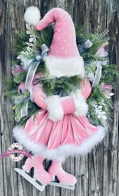 a pink and white christmas wreath with santa hat