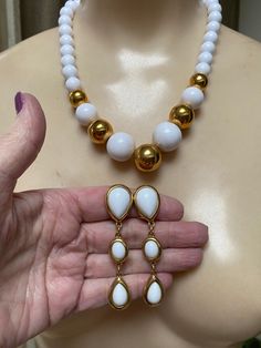 "You must have at least one set of white jewelry just for summer. White pearls don't count. I'm talking fun stuff. Necklace is signed Napier and earrings signed Trifari. Necklace will extend from 16 to 18\" with a hook clasp. Largest front beads are about 18 and 20mm round. They continue to be fairly big at about 10mm near clasp. Earrings are clip backs marked Trifari. Big look at 3\" but the largest section is against the earlobe. Not heavy anyway but I think the largest bead at top is a good i Modern White Teardrop Necklace, White Round Jewelry With Matching Earrings, White Pearl Drop Costume Jewelry, White Jewelry With Matching Earrings, White Costume Jewelry For Formal Occasions, White Teardrop Jewelry Sets With Matching Earrings, White Teardrop Jewelry For Formal Occasions, Modern White Jewelry With Round Beads, White Dangle Jewelry Sets For Formal Occasions