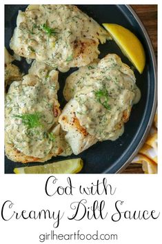 chicken with creamy dill sauce in a skillet and lemon wedges on the side