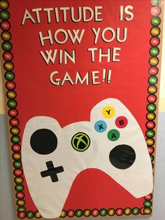 a sign that says attitude is how you win the game with a video game controller on it