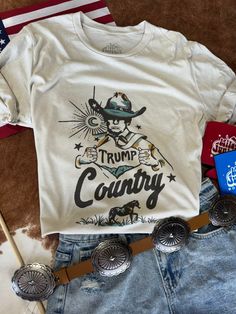 Stand out and show your support with Trump Country Western Graphic Tee. This eye-catching tee combines political flair with a touch of western style, perfect for supporters looking to show their enthusiasm in a unique way. Unisex fit Made in the USA Bday Wishlist, Casual Outfits For Moms, Western Graphic Tees, Outfits For Moms, Timor Leste, Plus Size Shopping, Blankets For Sale, Country Western, Caicos Islands