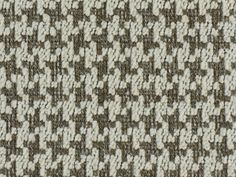 a close up view of the texture of a carpet with brown and white squares on it