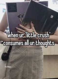 a woman holding a laptop in her hands with the words when ur little crush consumes all