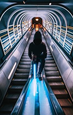 a man sitting on an escalator in a subway