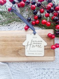 a wooden cutting board with a house ornament on it