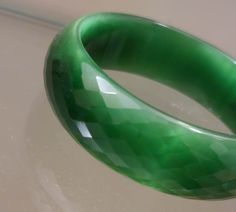 Genuine Natural Green Cat Eye Faceted Glass Bangle Crystal Crystal Emerald green Cat Eye Bangle Lovely like new Emerald Green Glass Bangle.. comes in its own gift box.. would make a nice gift. It is .75 inches wide and 2.40 inches in diameter so a little smaller than common size bangles.. Has some weight to it Rectangular Green Bracelets As Gifts, Green Rectangular Bracelets As Gifts, Green Handmade Bracelets For Formal Events, Green Handmade Bracelets For Formal Occasions, Green Cat Eye, Green Cat, Glass Bangles, Faceted Glass, Green Glass