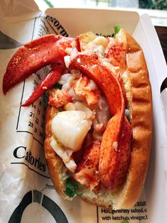 a lobster sandwich is on a paper tray