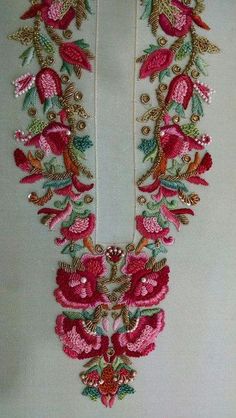 an embroidered necklace with pink flowers and green leaves