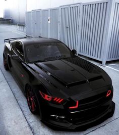 a black sports car parked in front of a building