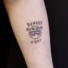 a tattoo on the arm that says beware of goree with a cartoon character