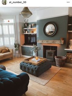 a living room filled with furniture and a fire place under a mirror on the wall