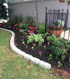 a flower bed in front of a house