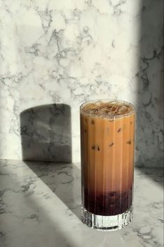 an iced drink sitting on top of a marble counter