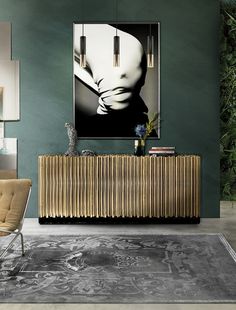 a modern living room with green walls and art work on the wall, along with an antique radiator