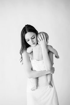 a woman holding a baby in her arms