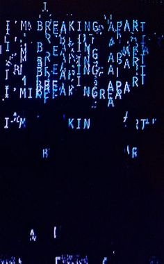 the words are lit up in blue and white on a black background that is very dark