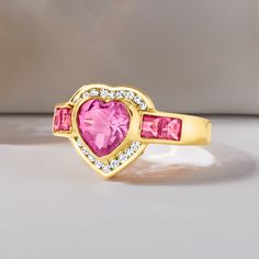 Ross-Simons - 3.20ct t. w. Pink Topaz, .18ct t. w. Diamond Heart Ring Over Sterling. Size 8. Stand out on date night with our glitzy ring! It flaunts a radiant 2.00 carat heart-shaped pink topaz accentuated by a sparkly halo of .18 ct. t. w. round diamonds and additional 1.20 ct. t. w. square pink topaz gems trailing either side. Crafted in 18kt yellow gold over sterling silver. 1/2" wide. Diamond and pink topaz heart ring. Glamorous Rings With Vs Clarity For Anniversary, Glamorous Anniversary Rings With Vs Clarity, Fine Jewelry Rings With Brilliant Cut For Valentine's Day, Luxury Diamond Ring With Gemstone For Valentine's Day, Cubic Zirconia Birthstone Ring With Accent Stones For Proposal, Valentine's Day Proposal Diamond Ring In Fine Jewelry Style, Valentine's Day Pink Cubic Zirconia Diamond Ring, Valentine's Day Yellow Gold Diamond Ring With Center Stone, Valentine's Day Diamond Ring With Accent Stones