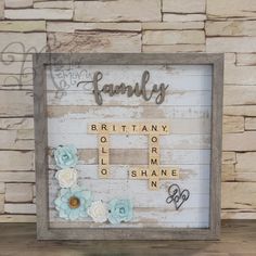 a family scrabble frame with flowers on it