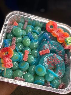 a tray filled with gummy bears and other candies