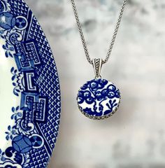 "Beautiful and timeless! Broken china jewelry is a lovely traditional china gift to celebrate your 20th wedding anniversary with your wife. She will love her handmade jewelry carved from vintage china and set in sterling silver! Our broken china necklace features a beautiful tree from the iconic blue and white pattern on the classic Blue Willow design. Unique vintage blue willow china, sterling silver filigree setting. ( 7/8\" round, lightly antiqued) Includes our favorite 16\" popcorn style ste Blue Engraved Amulet Jewelry, Blue Engraved Amulet Style Jewelry, Blue Medallion Necklaces For Wedding, Blue Medallion Necklace For Wedding, Etched Necklaces For Anniversary, Blue Locket Necklace For Wedding, Etched Round Necklace For Anniversary, Etched Necklace For Anniversary, Blue Medallion Jewelry For Gifts