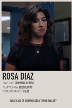 a woman in black shirt standing next to a wall with words on it and an ad for rosa diaz