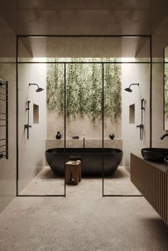 a bathroom with a large black bathtub next to a walk in shower