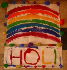 there is a sign with the word holi painted on it and some candy around it