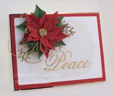 a close up of a christmas card with poinsettis