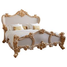 an ornate gold and white bed frame with pillows on the headboard, in front of a white background