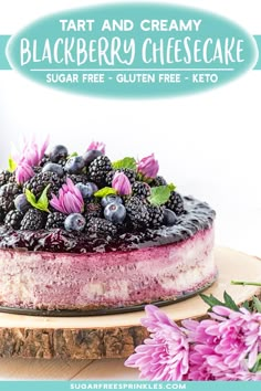 a blueberry cheesecake with fresh blackberries and purple flowers on a wooden board