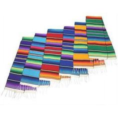 multicolored table runners with fringes on each side and one in the middle