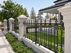 a black and white fence next to a house