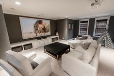 a living room filled with furniture and a flat screen tv mounted to the side of a wall