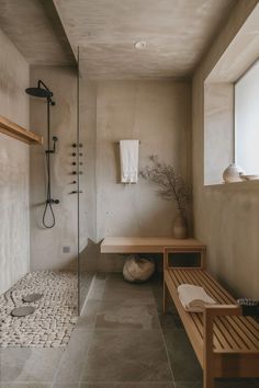 a bathroom with two benches and a shower