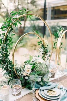 an image of a table setting with flowers and greenery