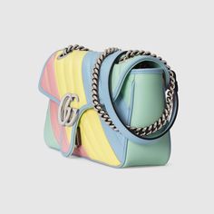 Description Pastels push the color focus throughout the Pre-Fall 2020 collection, in soft, vibrant hues. Made in matelassé chevron leather with a heart on the back in a stripes of light yellow, green, blue and pink, the now recognizable small GG Marmont chain shoulder bag has a softly structured shape and a flap closure with Double G hardware. Designed to be in multiple ways, the chain strap slides to change between a shoulder and a top handle bag. Size: 10″W x 6″H x 3″D / 2 5 x 12.2 x 7.6 cm 100% genuine materials, matching the quality of the Gucci product; Multicolored pastel diagonal matelassé leather Palladium-toned hardware Microfiber lining with a suede-like finish Double G Interior zipper pocket Sliding chain strap can be as a shoulder strap with 22” drop, as a top handle with 12” d Gg Marmont Small Shoulder Bag, Saint Laurent Handbags, Gucci Marmont, Gucci Gg Marmont, Card Case Wallet, Gg Marmont, Pink Backpack, Small Shoulder Bag, Chain Shoulder Bag