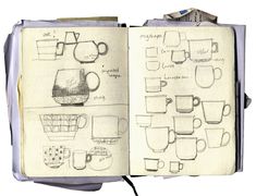 an open notebook with coffee cups and mugs drawn on the pages, including one