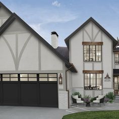 this is an artist's rendering of a two - story house with large garages