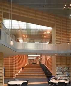 the inside of a library with tables and chairs