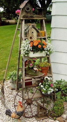 an old ladder is filled with potted flowers and other things to decorate it for the garden