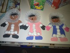 three paper dolls made to look like people